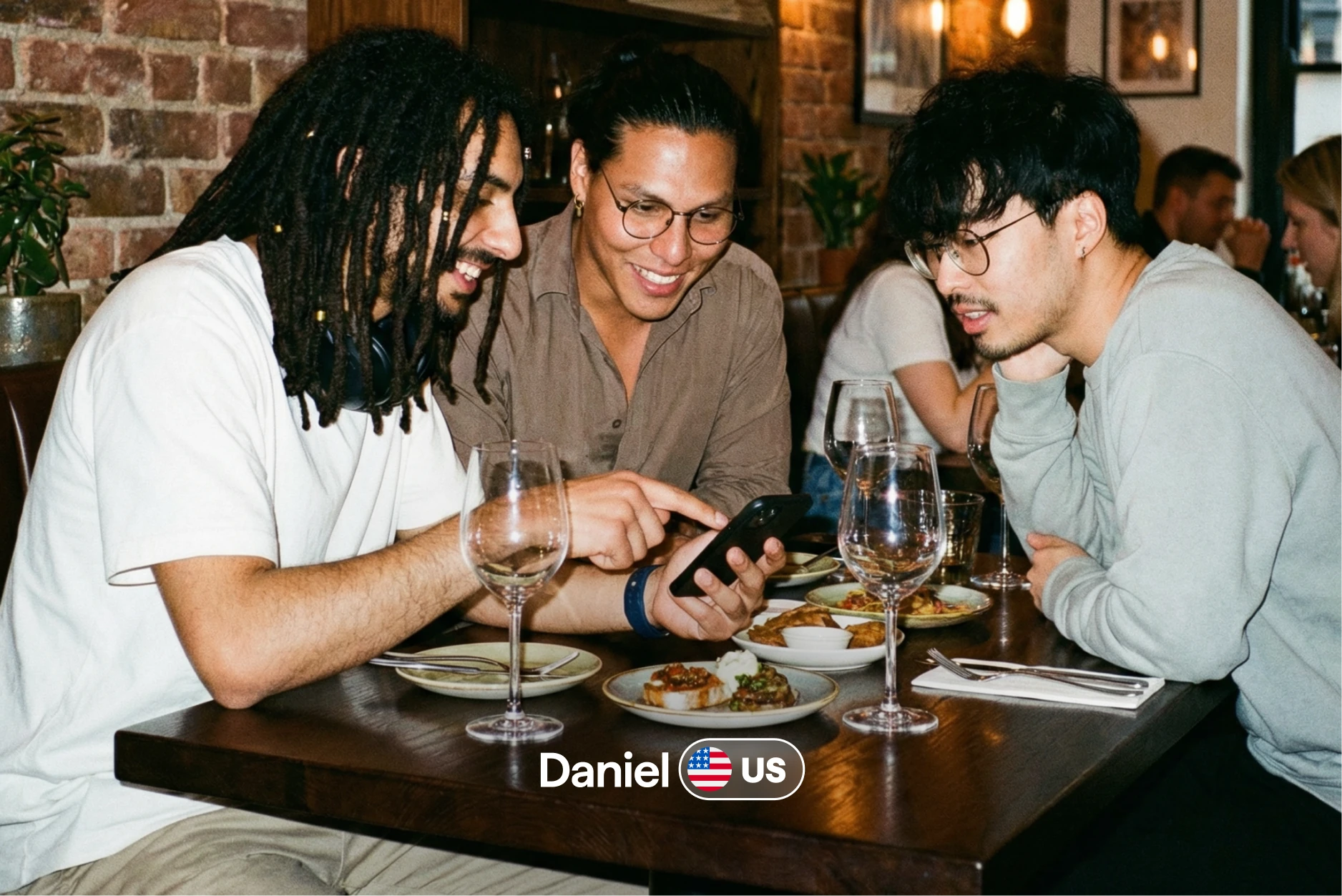 Daniel from the US sharing a restaurant moment with two friends over dinner