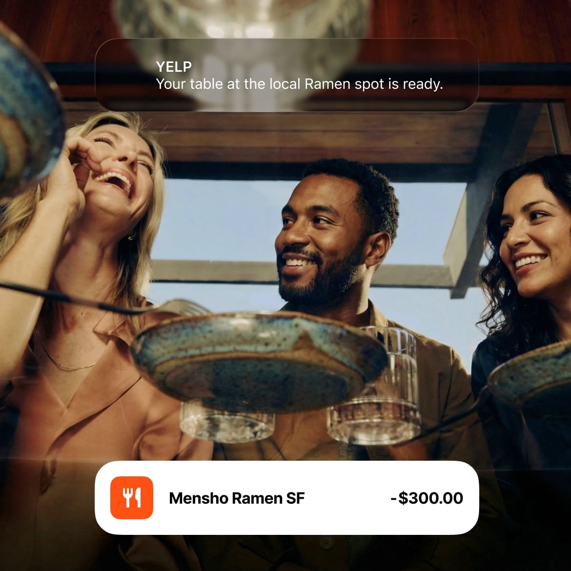 Friends laughing at a ramen restaurant with a Yelp reservation and $300 Mensho Ramen SF transaction